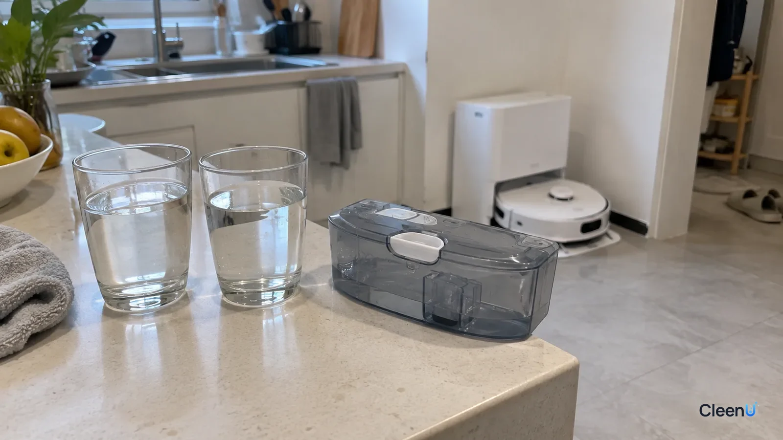 AI illustration: Two glasses of water beside a translucent robot mop water tank on a counter