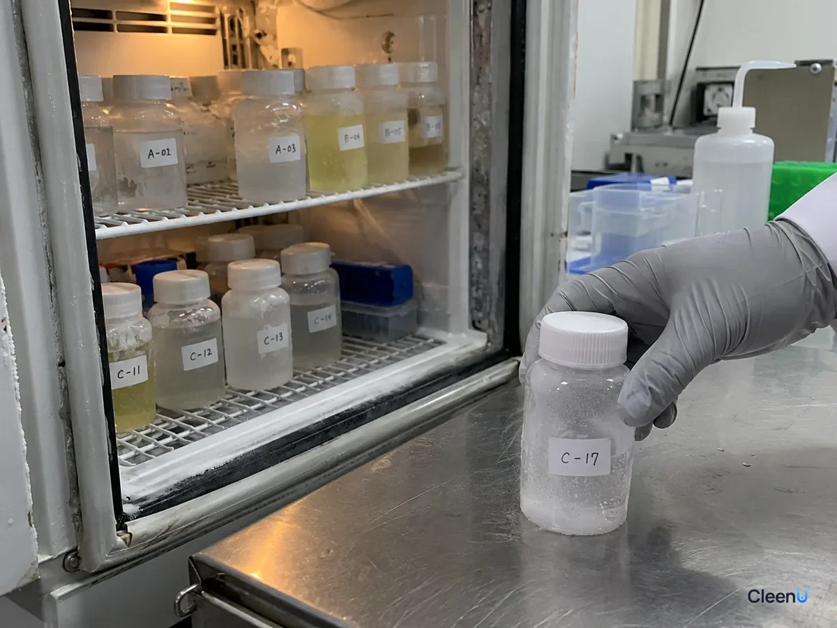 AI illustration: Sample bottles inside a cold chamber, with a gloved hand holding one bottle