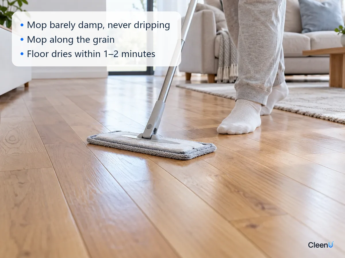 AI illustration: A person pushing a microfiber flat mop along the grain of a hardwood floor