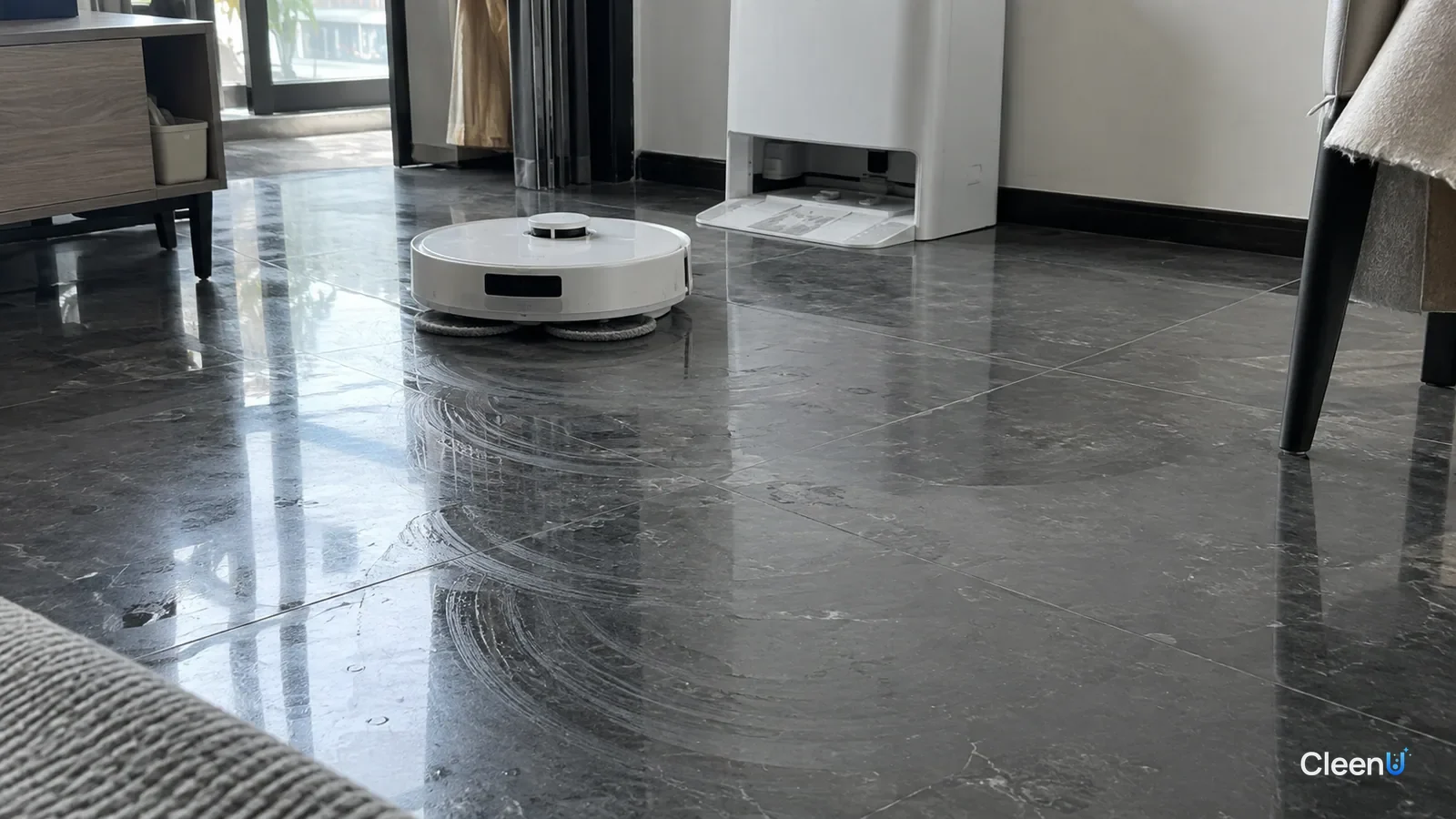 AI illustration: Dark polished tile in side light showing curved, circular streaks left by a robot mop's spinning pads