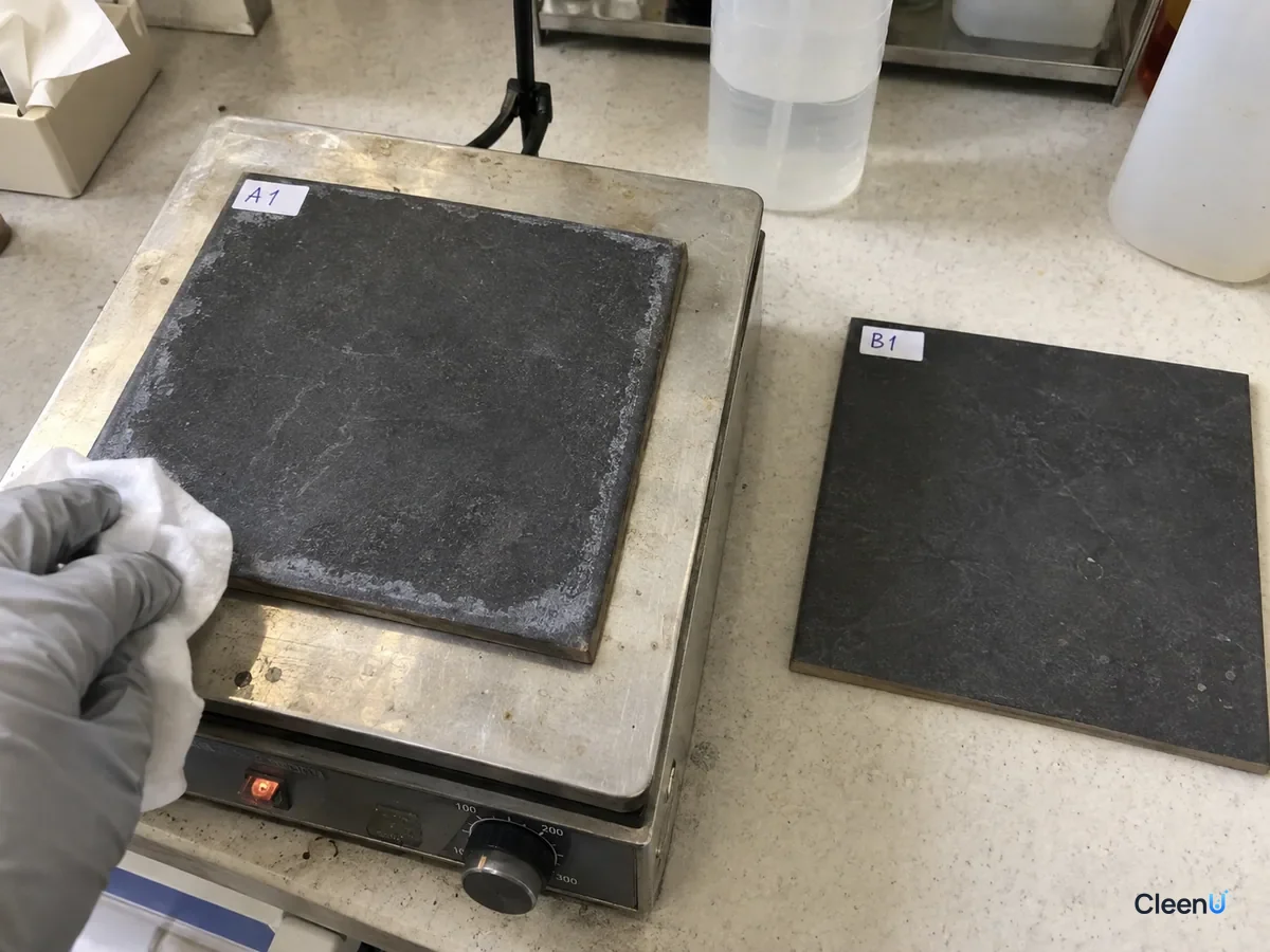 AI illustration: A dark tile sample with white marks on a hot plate beside another tile sample