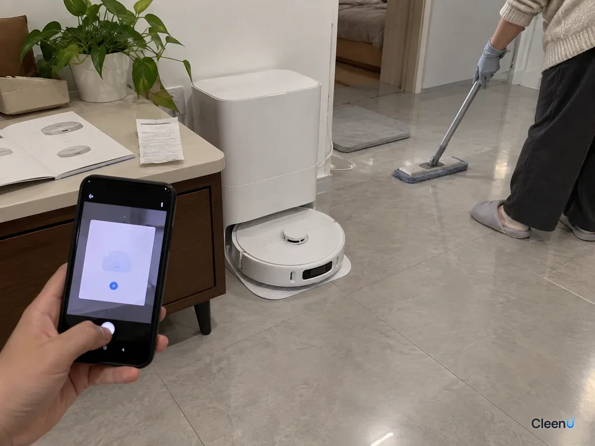 AI illustration: A phone, an instruction manual and a receipt beside a robot mop dock
